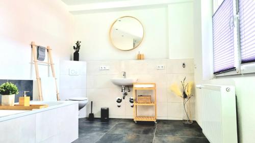 a bathroom with a sink and a mirror at Design Apartment in Göttingen in Göttingen