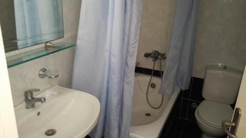 a bathroom with a sink and a toilet and a shower at Anetis Hotel in Tsilivi