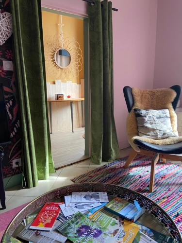 a living room with a glass table and a chair at Atipyk'ododo in Saint-James