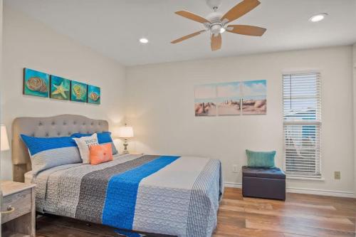 a bedroom with a bed and a ceiling fan at Fish Station Bike Rack BBQ Golf Cart Access in Port Aransas
