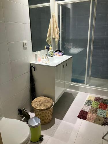 a bathroom with a shower and a sink and a toilet at Sol da Caparica in Costa da Caparica