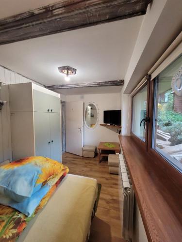 a bedroom with a bed and a large window at Agroturystyka Oblica in Zawoja