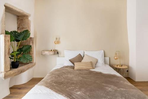 a bedroom with a large white bed with two pillows at Évasion de charme, maison authentique et spa privé in La Baume-de-Transit