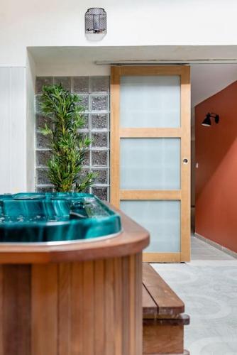 a bathroom with a blue sink and a door at Évasion de charme, maison authentique et spa privé in La Baume-de-Transit