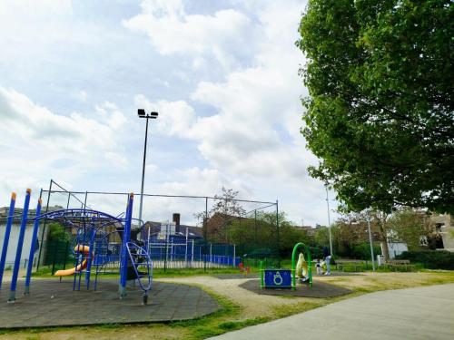 a playground in a park with a blue play structure at Révélation Liège in Liège