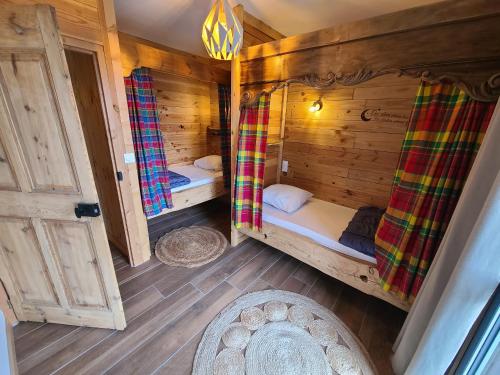 a room with two bunk beds in a cabin at Gites La Boletiere in Saint-Étienne-du-Valdonnez