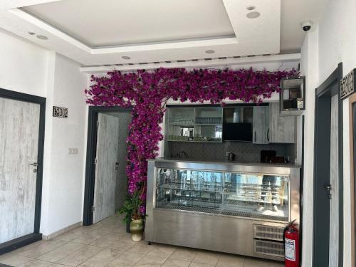 a restaurant with purple flowers on the wall at Tiana Butik Otel in Bodrum City