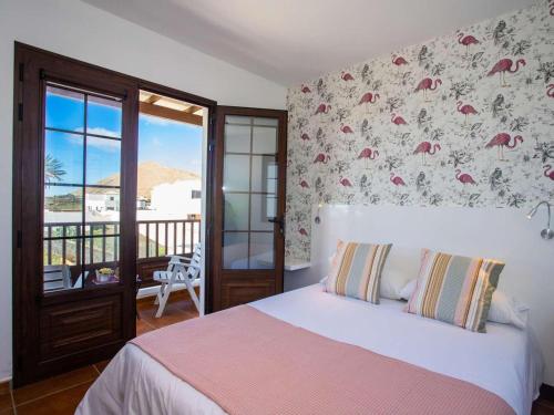 ein Schlafzimmer mit einem Bett und einem Balkon in der Unterkunft Villa Palmera La Vegueta Villas in Tinajo