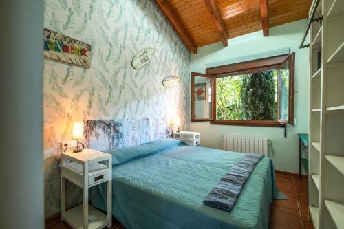 a bedroom with a bed and a table and a window at Villa La Marquesa de Llanes in Llanes