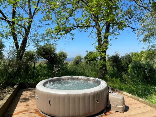 a hot tub sitting on a deck in a yard at Villa del Monte di Cocco in Massarosa