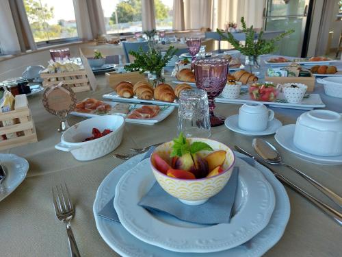 a table with a bowl of fruit and plates of food at Le Casette di Giò in Monteodorisio