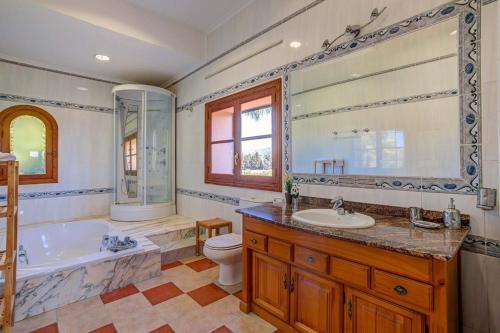 a bathroom with a tub and a toilet and a sink at Villa Selva in Inca