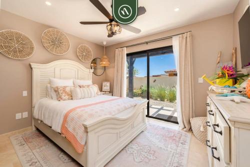 a bedroom with a bed and a sliding glass door at Copala at Quivira 71 in Cabo San Lucas
