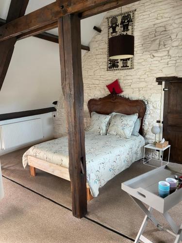 a bedroom with a bed with a wooden frame at Atipyk'ododo in Saint-James