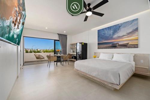 een slaapkamer met een bed en een eetkamer met een tafel bij Amazing 2BR Condo with Terrace Overlooking the Marina in Cabo San Lucas