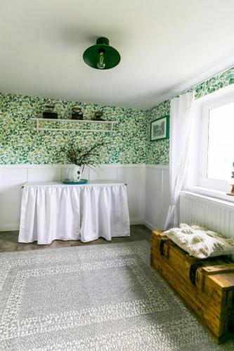 a room with a table and a window and a rug at Kłodnia 1 in Rytel