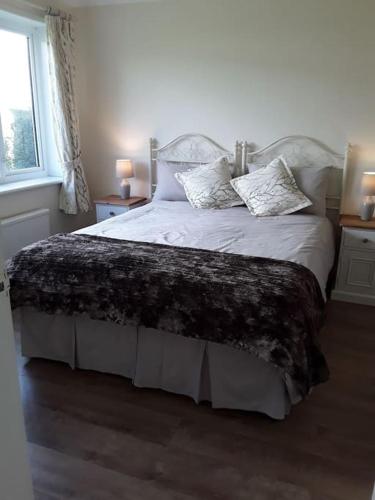 a bedroom with a bed with a blanket on it at Woodside ..Peaceful 1 bedroom ground floor lodge in Louth