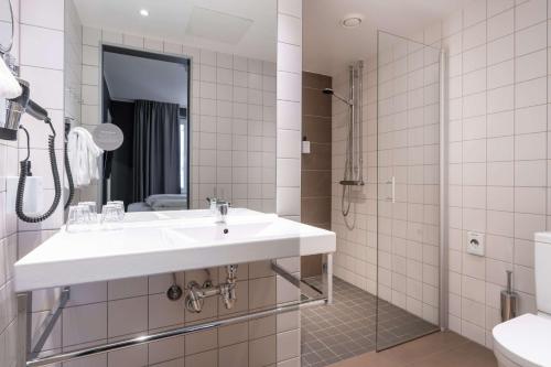 a bathroom with a sink and a shower at Scandic Vulkan in Oslo