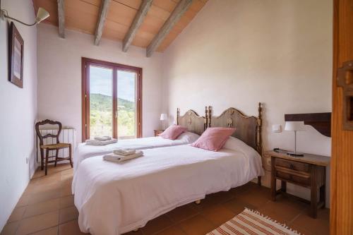 a bedroom with two beds and a window at Font in Artá