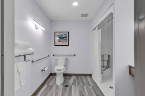 a white bathroom with a toilet and a shower at Hilton Garden Inn Myrtle Beach/Coastal Grand Mall in Myrtle Beach