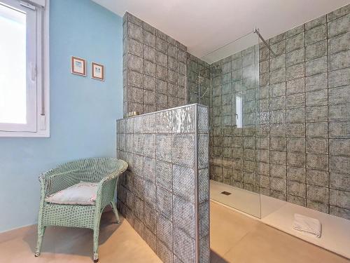 a bathroom with a shower and a chair at Villa Elisa - 3510 in Mar de Cristal