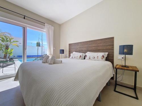 a bedroom with a large bed and a large window at Villa Elisa - 3510 in Mar de Cristal