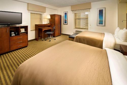 a hotel room with two beds and a desk at Comfort Inn Downtown DC/Convention Center in Washington, D.C.