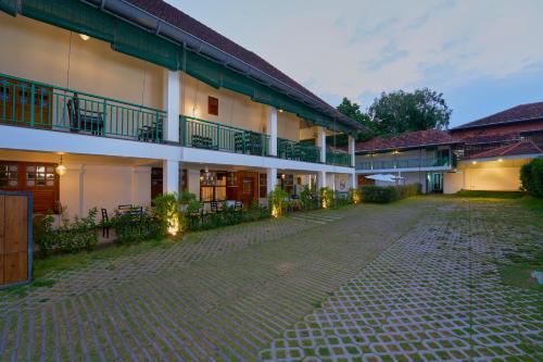 a courtyard of a building with a cobblestone street at Napier Heritage in Cochin