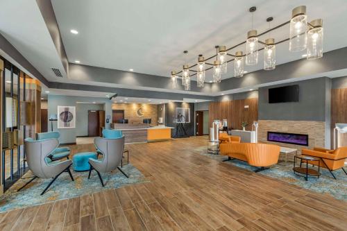 a lobby of a hotel with chairs and tables at Comfort Suites Cheyenne in Cheyenne