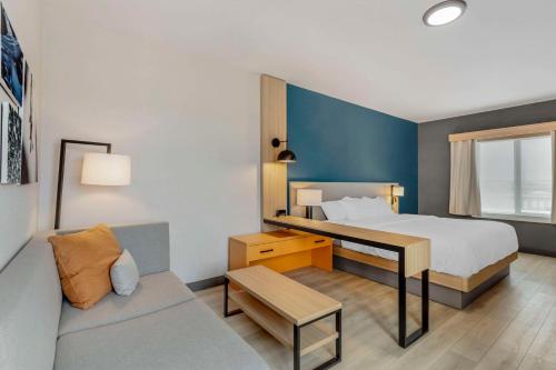 Habitación de hotel con cama y sofá en Comfort Suites Cheyenne, en Cheyenne