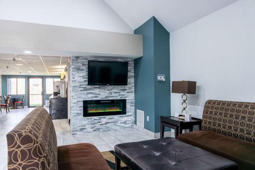 a living room with a couch and a fireplace at Quality Inn in Carrollton