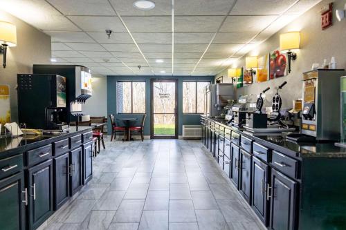 a large kitchen with black counter tops in a restaurant at Quality Inn in Carrollton