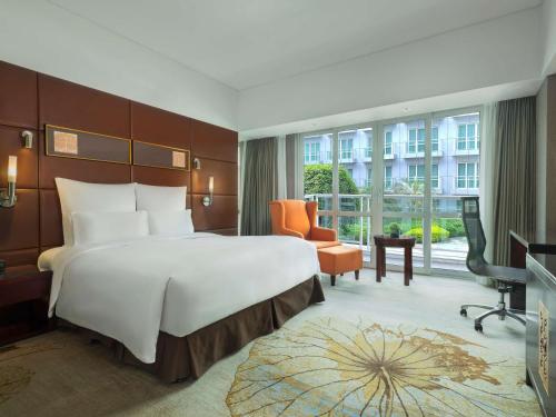 um quarto de hotel com uma cama grande e uma secretária em Pullman Guangzhou Baiyun Airport em Guangzhou