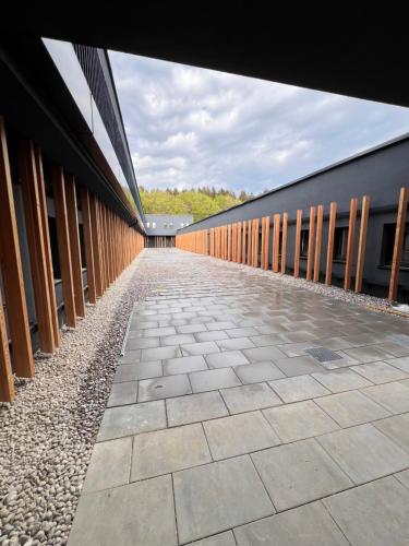 a building with a walkway next to a building at Firstsleep Ebersberg in Ebersberg