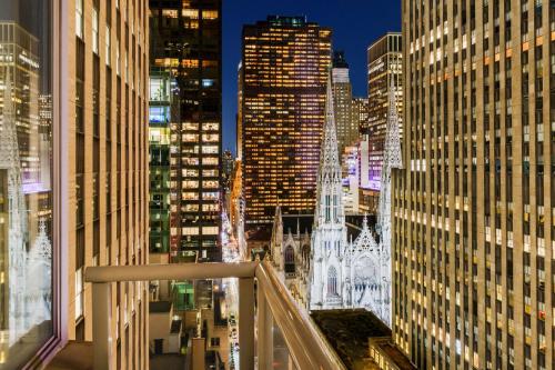 a view of a city at night with tall buildings at DoubleTree by Hilton New York Midtown Fifth Ave in New York