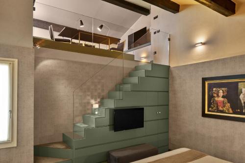 a living room with a staircase and a television at Hotel Accademia in Verona