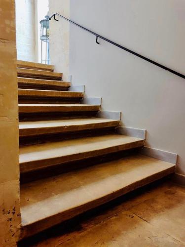 a staircase in a building with a stair railing at Casa Birmula Boutique Hotel in Cospicua