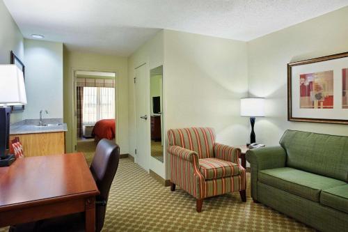 a living room with a couch and a chair at Country Inn & Suites by Radisson, Rock Falls, IL in Rock Falls