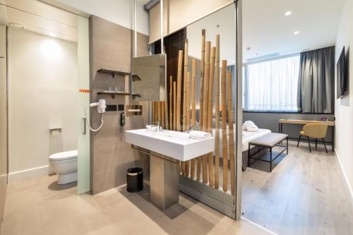 a bathroom with a sink and a toilet at Alexandre Fira Congress in Hospitalet de Llobregat