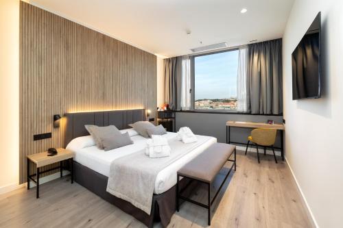 a hotel room with a large bed and a window at Alexandre Fira Congress in Hospitalet de Llobregat