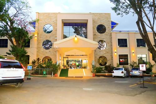 a white car parked in front of a building at Sportsview Hotel Kasarani in Nairobi