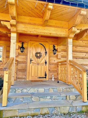 a wooden front door of a log cabin at Marusina Chalets in Szaflary