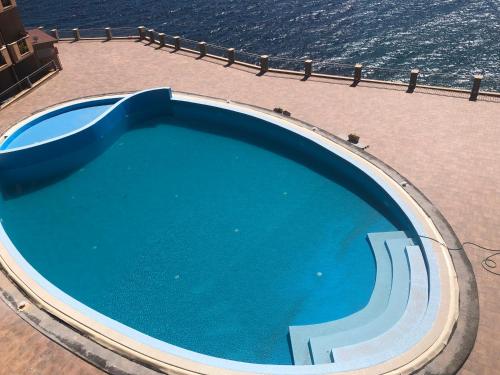 a large blue swimming pool on top of a building at orizzonte mare in Teulada
