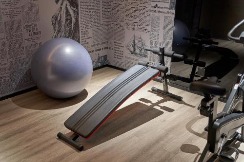 a gym with a fitness ball and a treadmill at Lan Wan Hotel - Next to Huangsha Metro St ation -One cup of Free Cockt ail or Harbin Beer Per Room--Cha rgeable Airport Pick-up Service in Guangzhou
