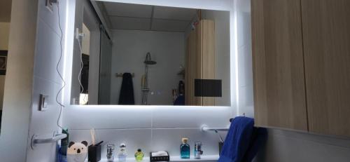 a bathroom with a large mirror above a sink at Magnificent Sunrise Studio in Benalmádena