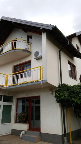 a white building with a balcony and a window at House Otes Ilidža in Sarajevo