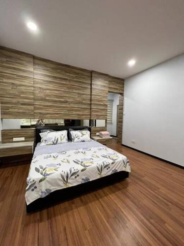 a bedroom with a large bed and a large screen at 1717 Bintulu Homestay 11 in Bintulu