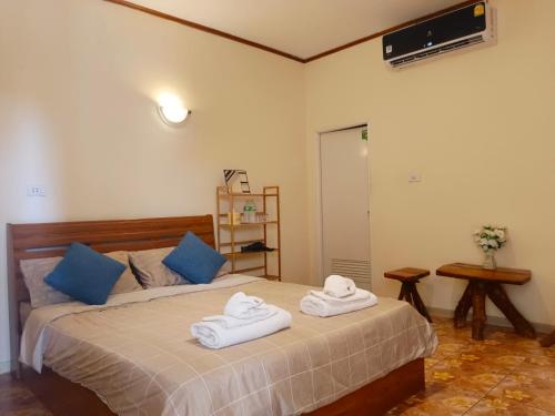 a bedroom with a bed with towels on it at Tiki Bar-KanTiang Guesthouse in Ko Lanta