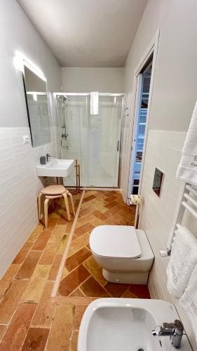 a bathroom with a toilet and a sink and a shower at B&B Serra Country House in Gradara