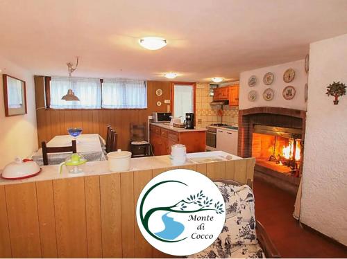a kitchen and living room with an amimate of coast sign on a counter at Villa del Monte di Cocco in Massarosa